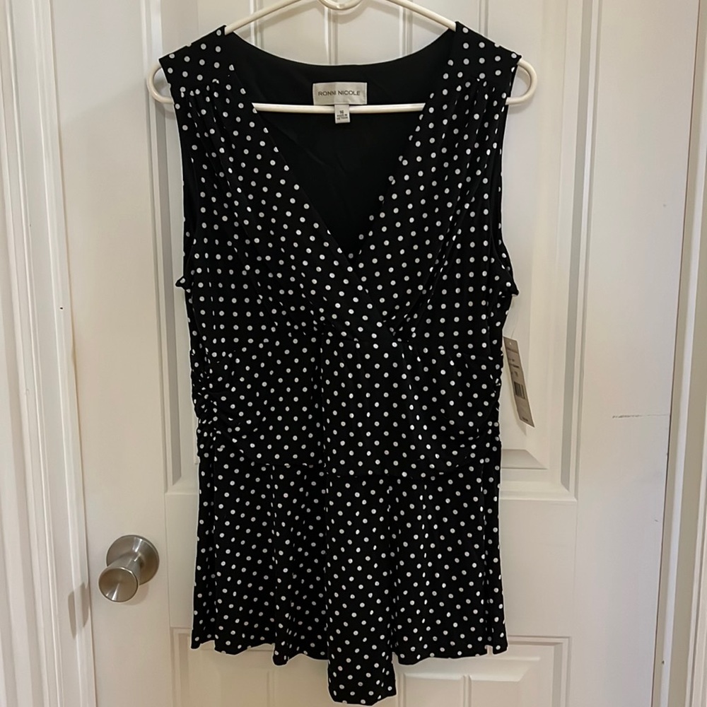 Sleeveless, black and white polka dot top.